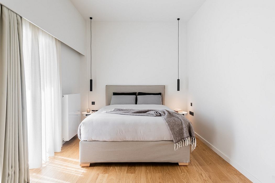 A minimalist, modern bedroom with a neutral color palette and clean-lined furnishings.