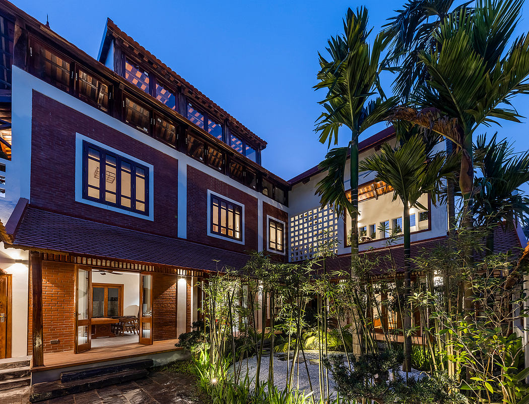 Tropical-inspired courtyard with traditional brick architecture and lush vegetation.
