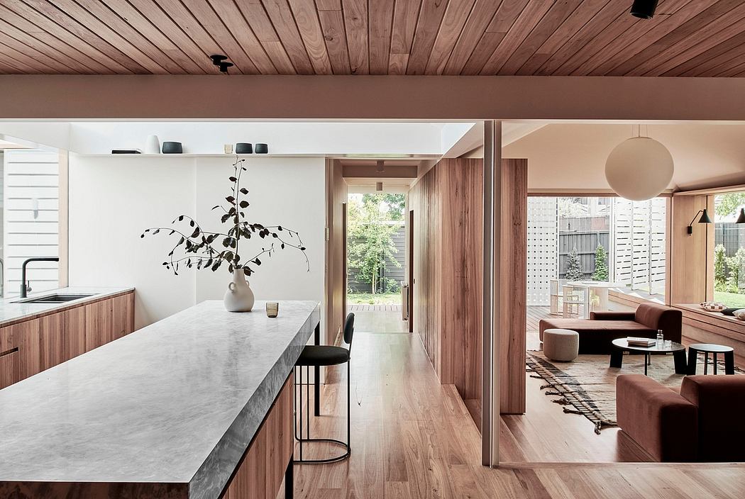 A modern, minimalist interior with clean lines, wood paneling, and a marble-topped island.