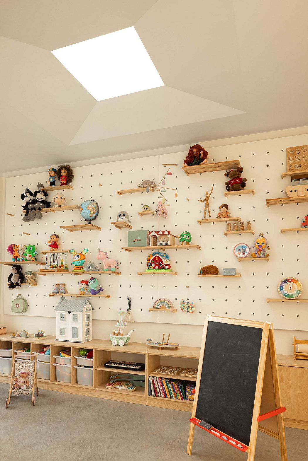 Playful, well-organized children's playroom with pegboard walls, shelves, and storage.