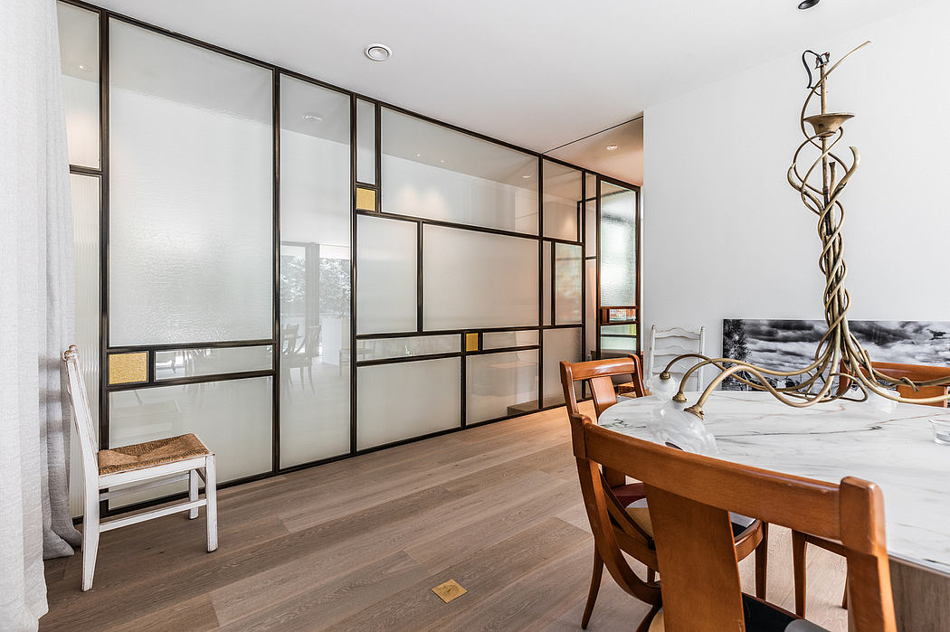 Sleek, modern interior with minimalist sliding glass panels, wooden furniture, and artistic lighting.