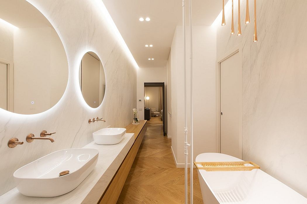 Elegant, modern bathroom with marble walls, wood vanity, and contemporary lighting fixtures.
