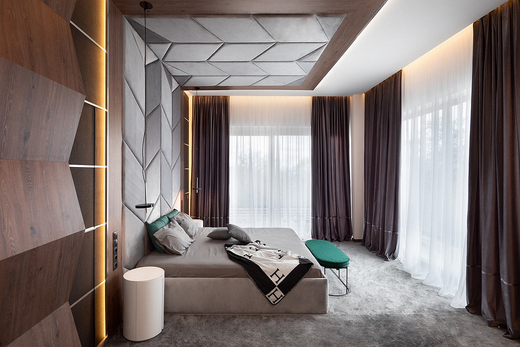 A modern bedroom with a geometric patterned ceiling, wooden panels, and large windows.