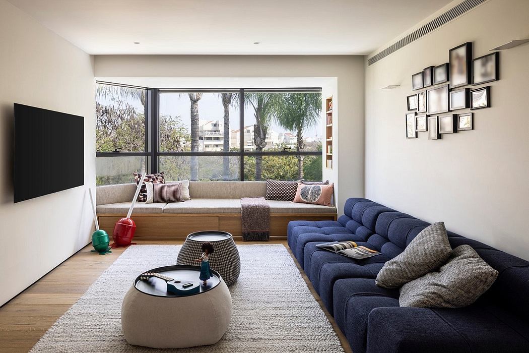 Spacious living room with large windows, plush seating, and a stylish layout.
