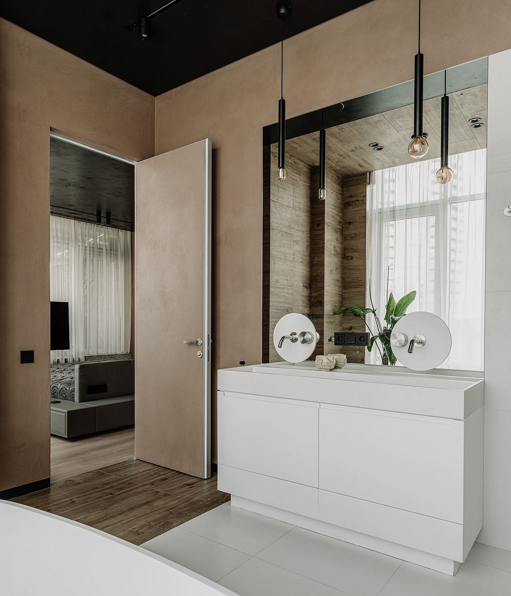 Sleek, minimalist interior with wood accents, pendant lights, and white vanity unit.