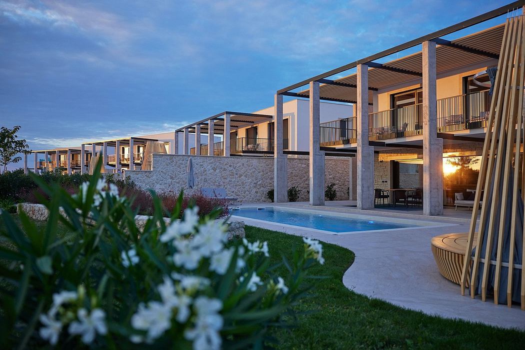 Luxurious resort with modern architectural features, pool, and lush greenery.