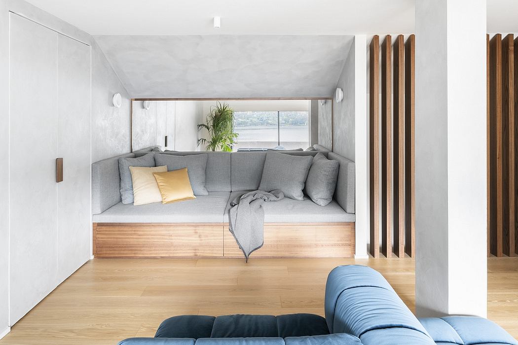 Cozy contemporary living space with built-in seating, wooden accents, and large window.