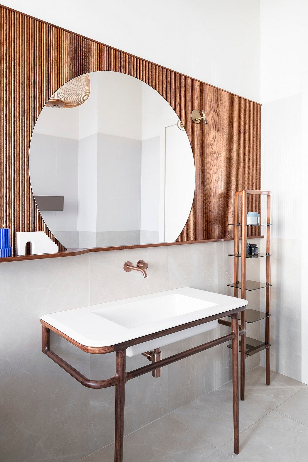 A modern bathroom with a large circular mirror, wooden slatted walls, and minimalist fixtures.