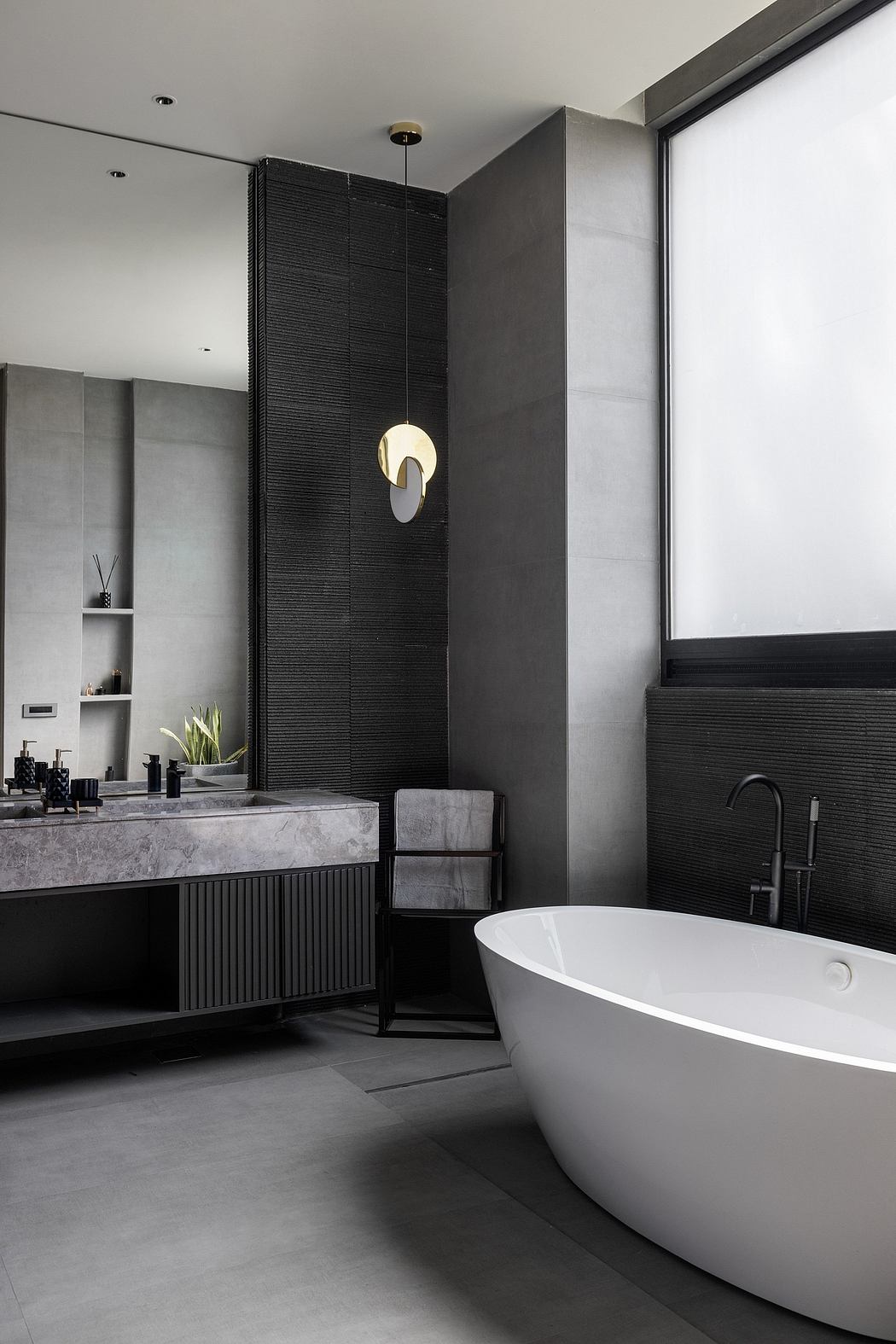 Sleek, contemporary bathroom with monochromatic color scheme, freestanding tub, and custom cabinetry.