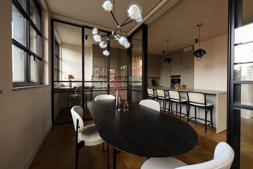 A modern open-concept kitchen and dining area with minimalist furniture and lighting.