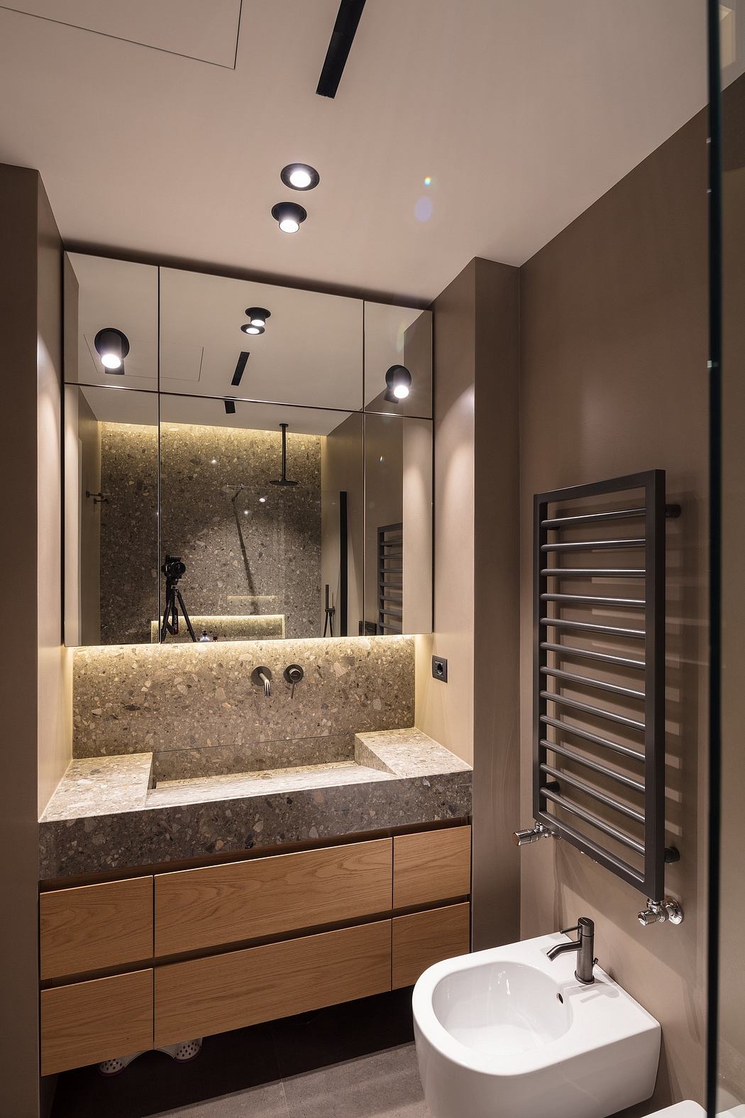 The bathroom features a modern design with sleek fixtures, a marble vanity, and recessed lighting.