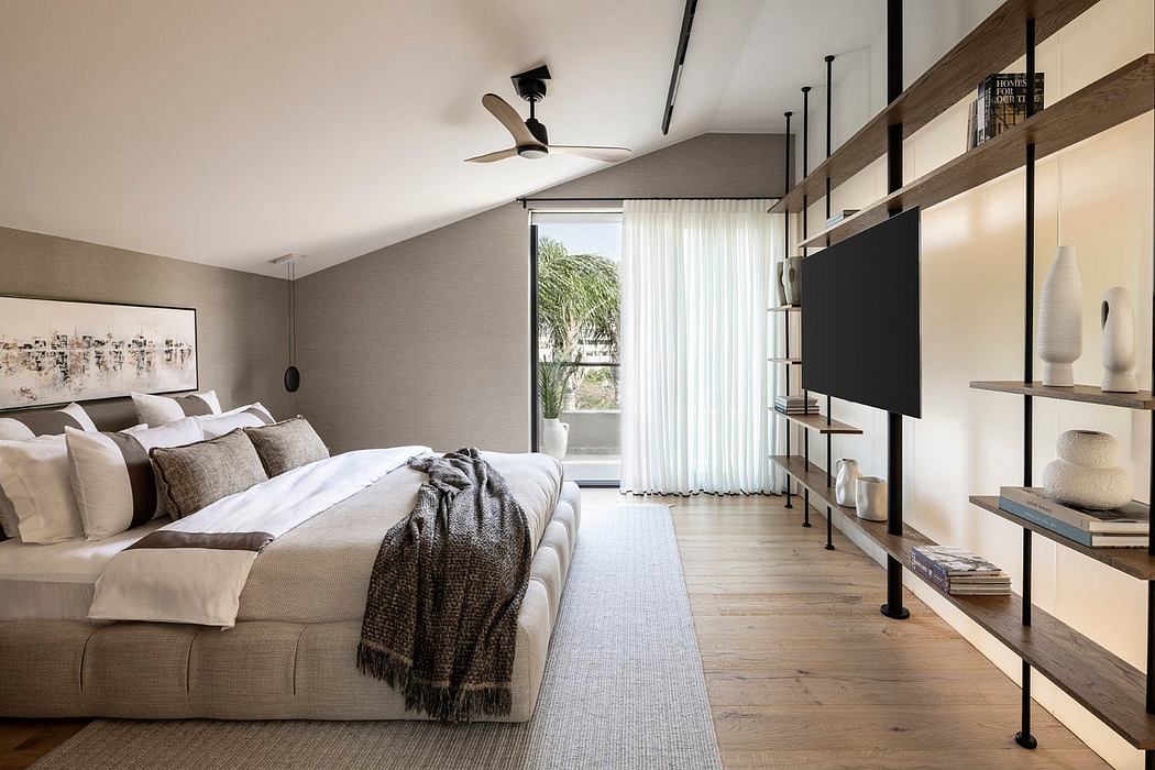 Spacious bedroom with modern amenities, warm tones, and minimalist shelving.