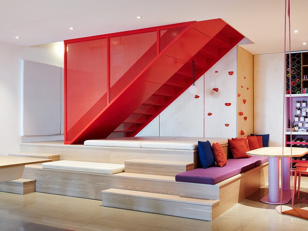 A striking red geometric staircase dominates the contemporary, open-concept interior.