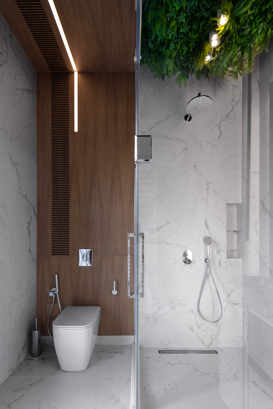 A modern bathroom with marble walls, a wooden vanity, and a hanging plant feature.