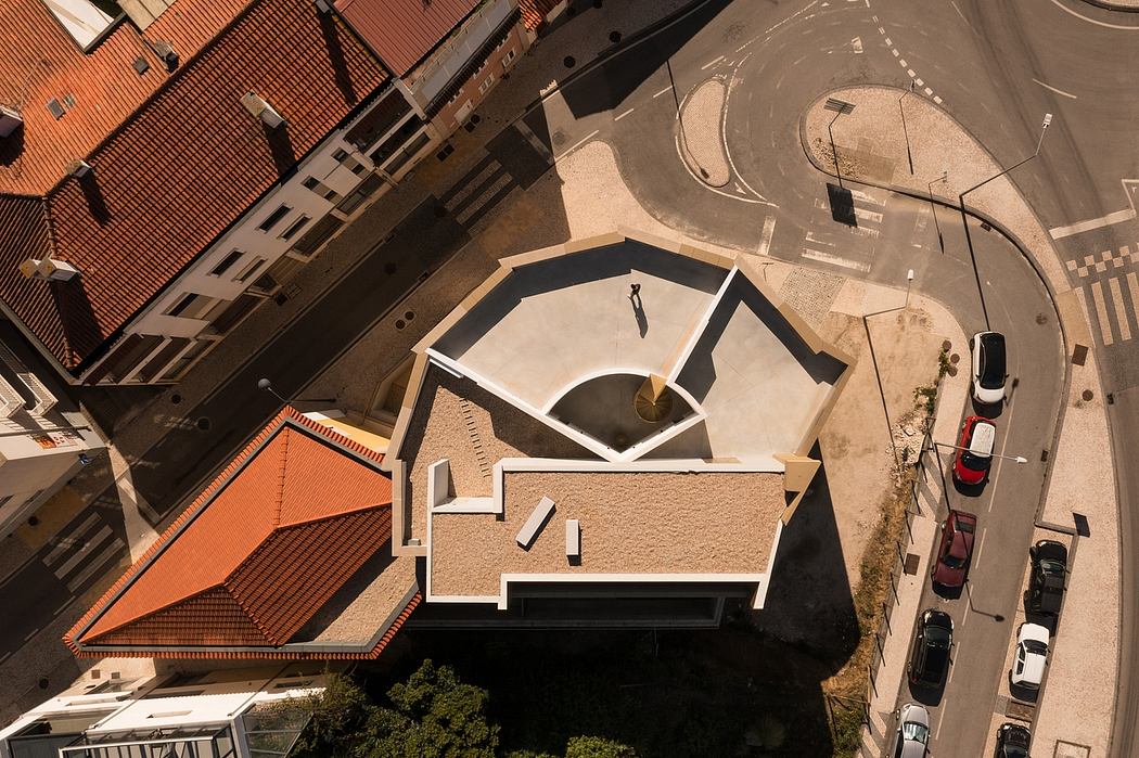 Geometric architectural details with orange tiled roofs and paved circular driveway.