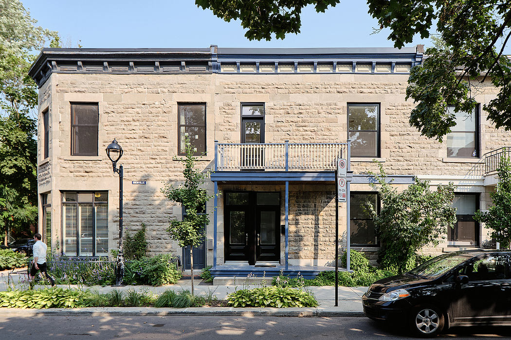 Stately stone building with ornate facade, inviting entrance, and surrounding greenery.