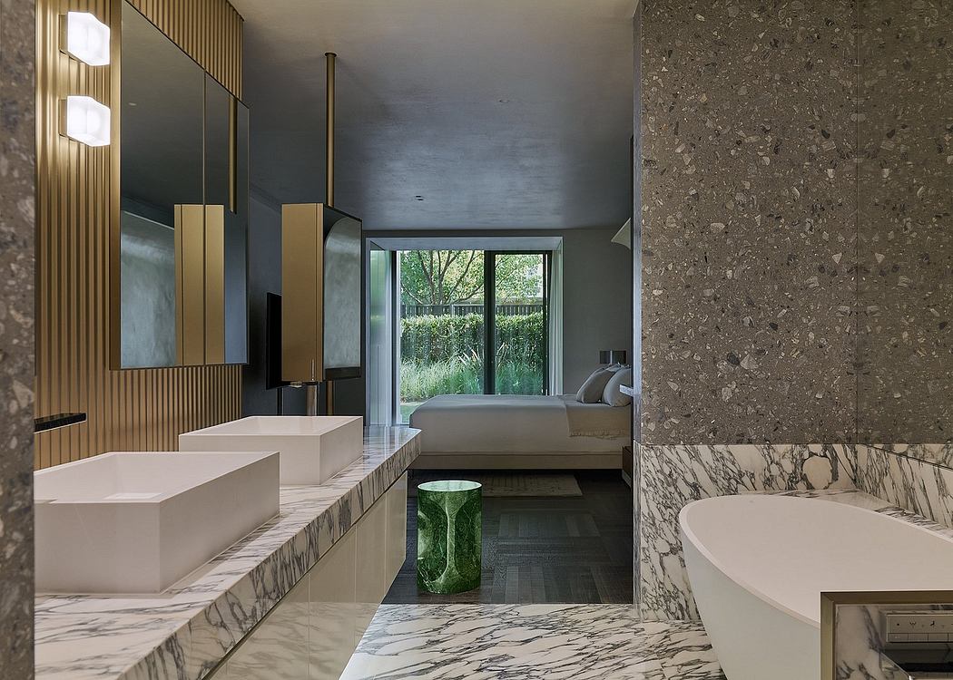 Luxurious modern bathroom with marble countertop, mirrored cabinets, and lush exterior view.