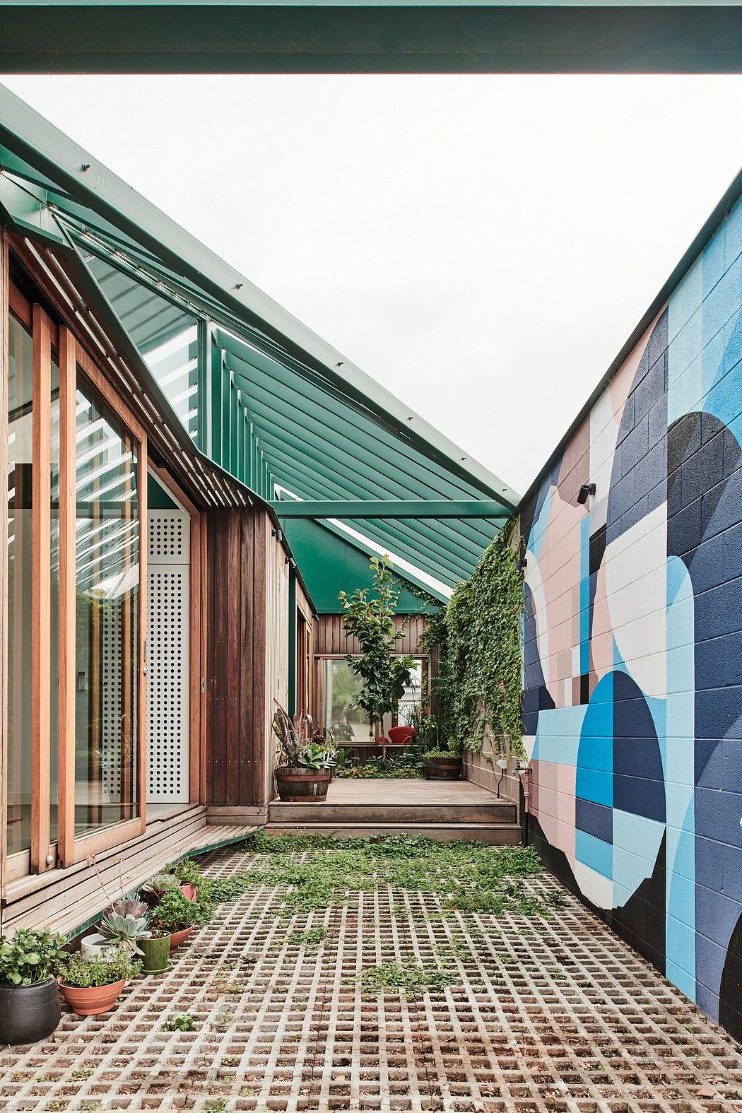 Vibrant exterior of a modern building with creative architectural elements and lush vegetation.