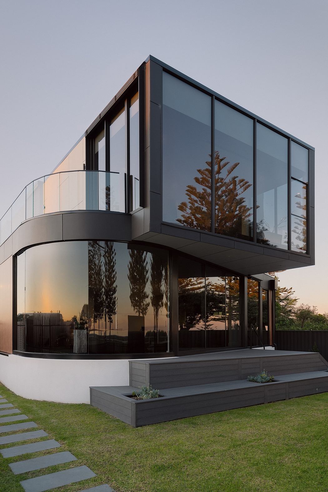 Modern architectural marvel with sleek glass facade, cantilevered design, and lush landscaping.