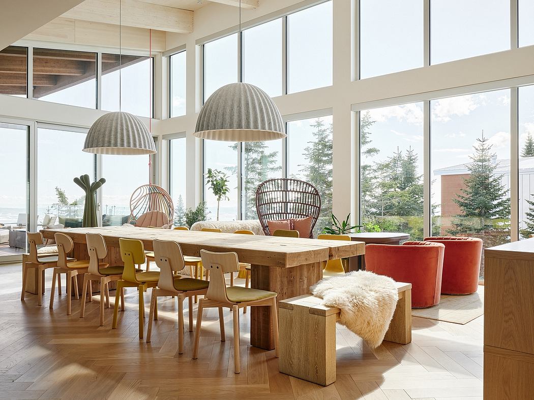 Spacious dining area with large windows, wooden furniture, and modern lighting fixtures.