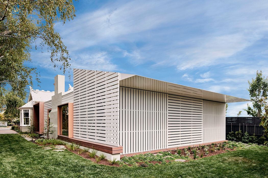 Modern architectural structure with distinctive slatted façade and landscaped grounds.