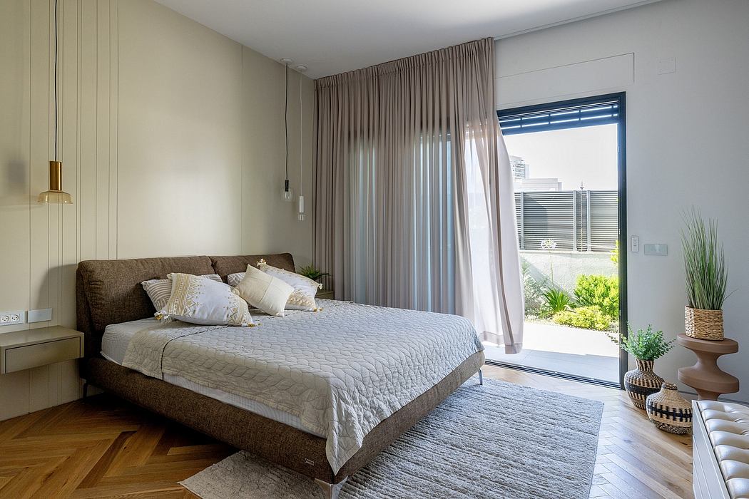 Spacious bedroom with plush bedding, floor-to-ceiling curtains, and a view of the garden.