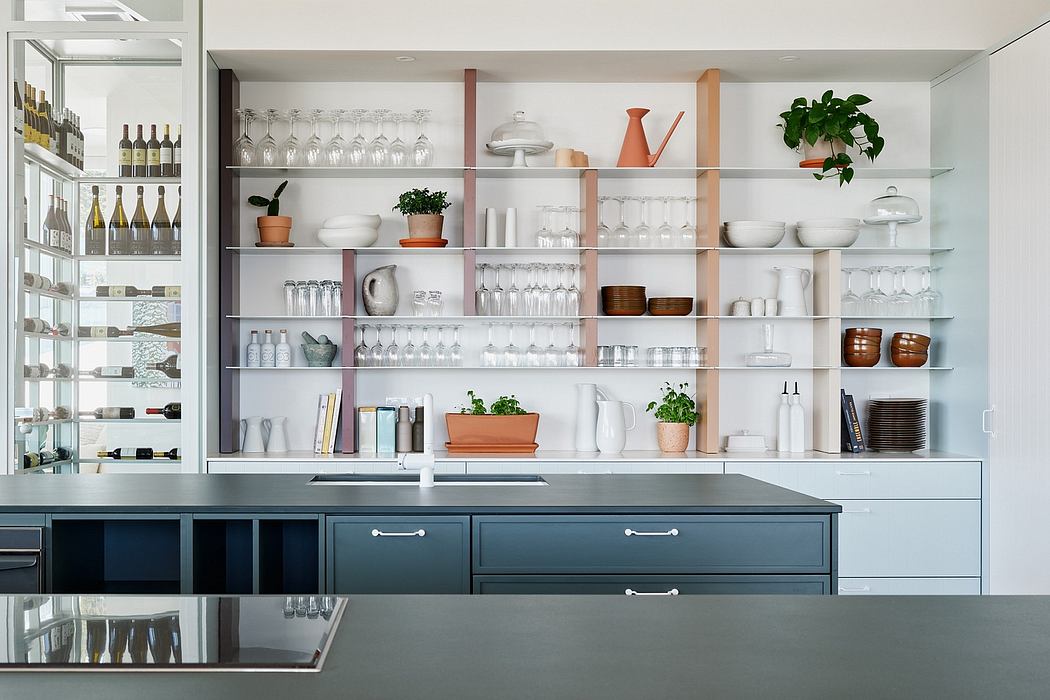 Well-organized kitchen with sleek dark drawers, open shelving, and artfully displayed kitchenware.