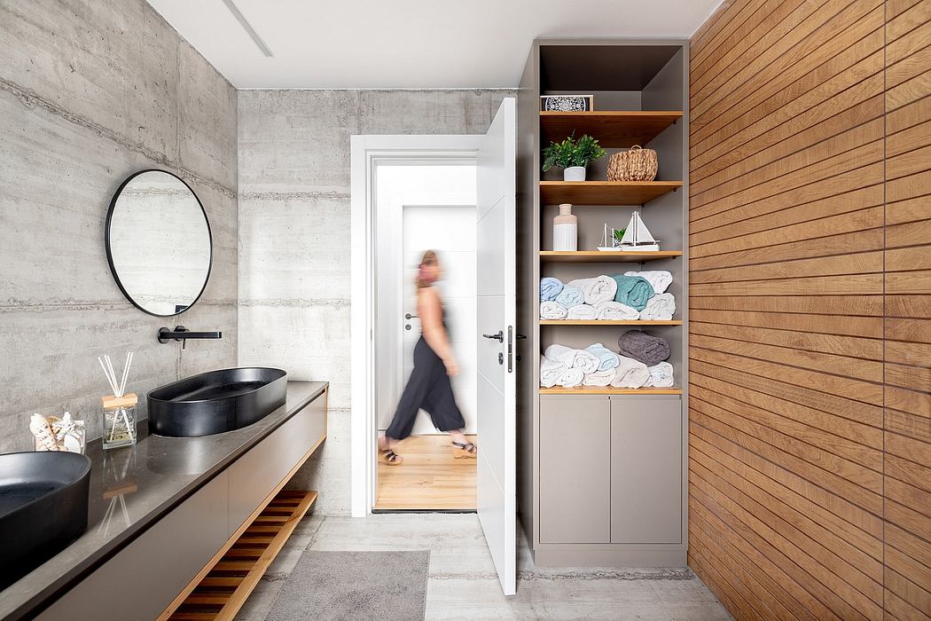 Sleek, modern bathroom with concrete walls, wooden shelving, and vessel sinks.