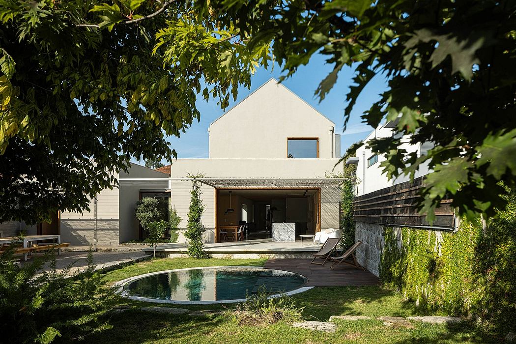 Modern house with pool, wooden deck, and lush green surroundings. Sleek architectural design.