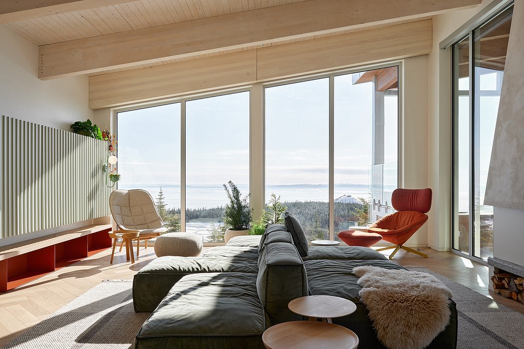 Spacious living room with large windows offering scenic mountain views, modern wood-paneled decor.