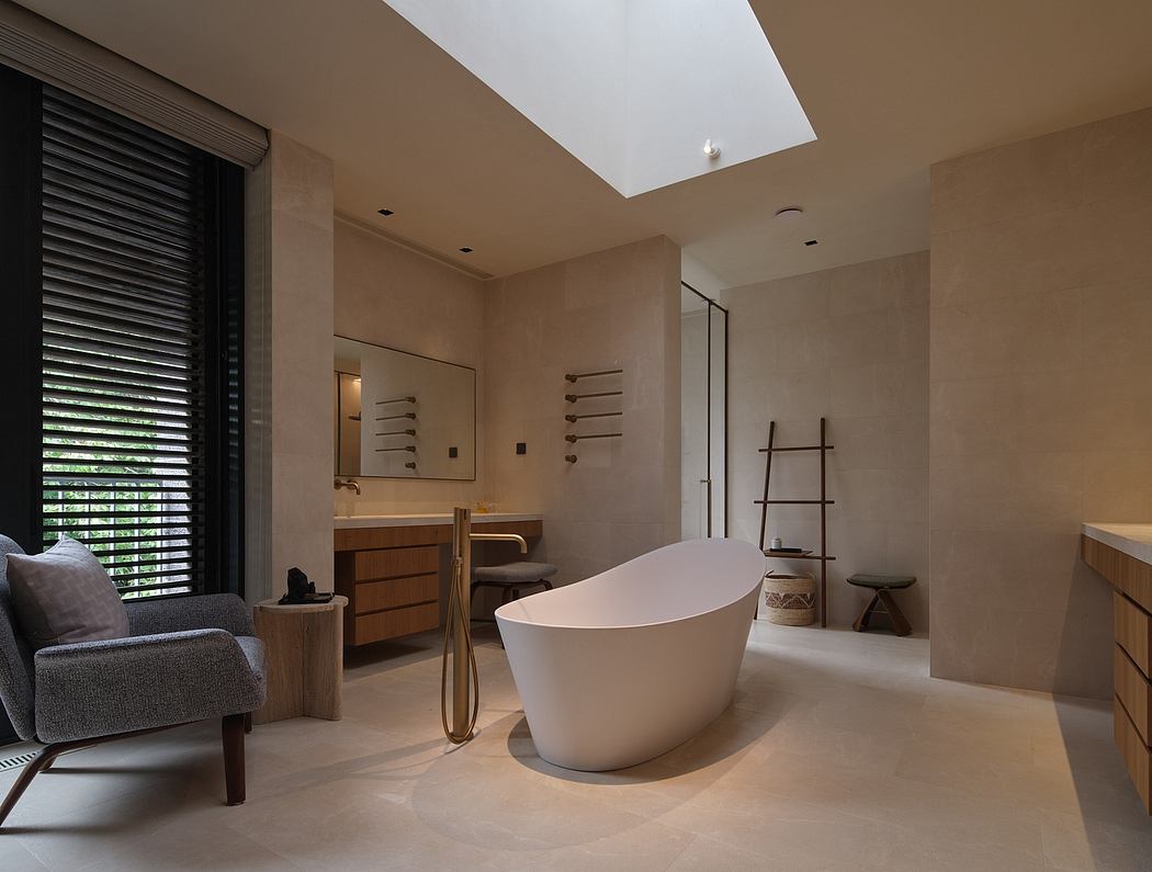 Minimalist bathroom with freestanding white tub, wooden vanity, and large window.