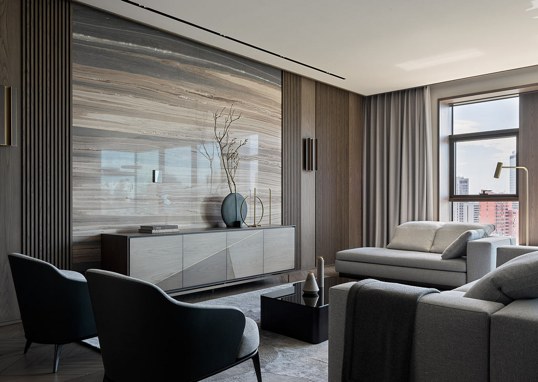Elegant modern living room with sleek wooden paneling, gray furnishings, and artistic decor.