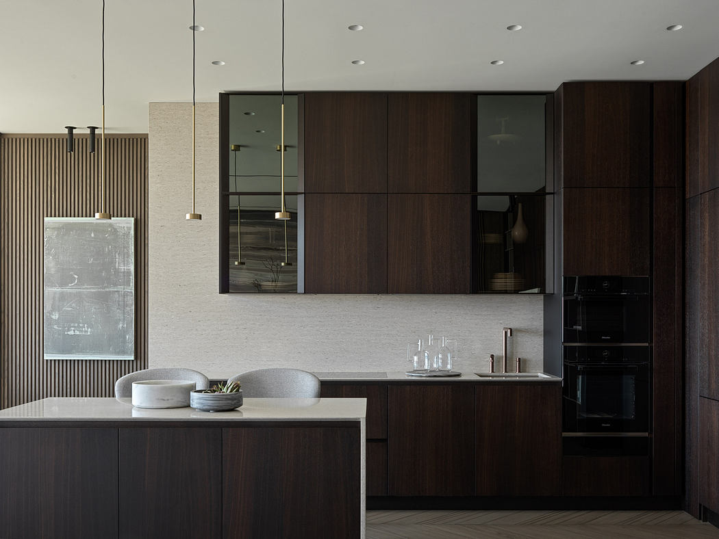 Sleek, modern kitchen with dark wood cabinets, minimalist design, and recessed lighting.