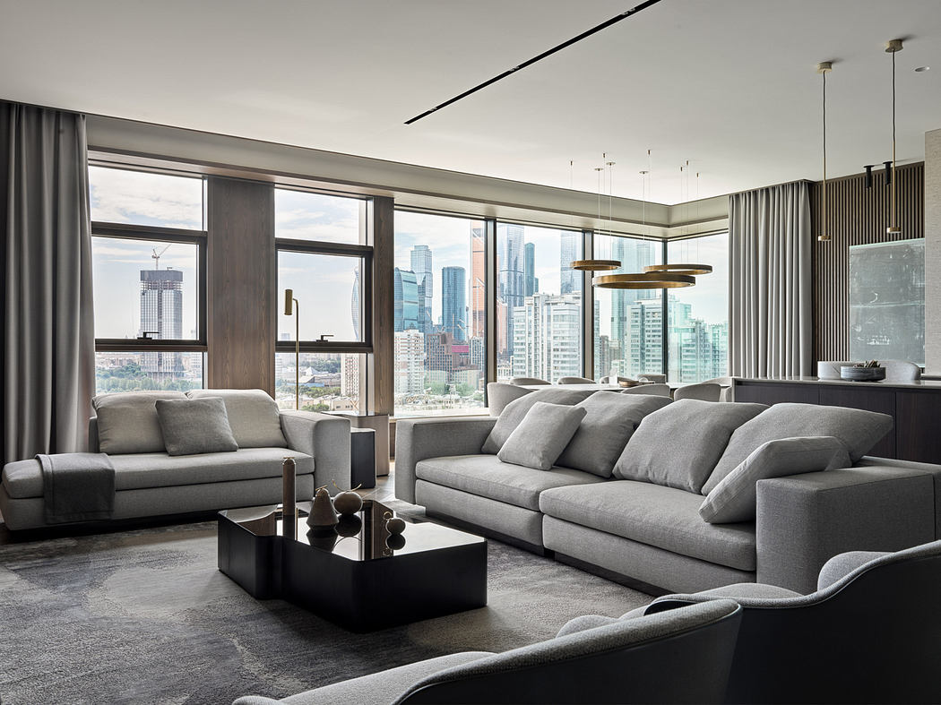 Spacious living room with floor-to-ceiling windows, modern furniture, and city skyline view.