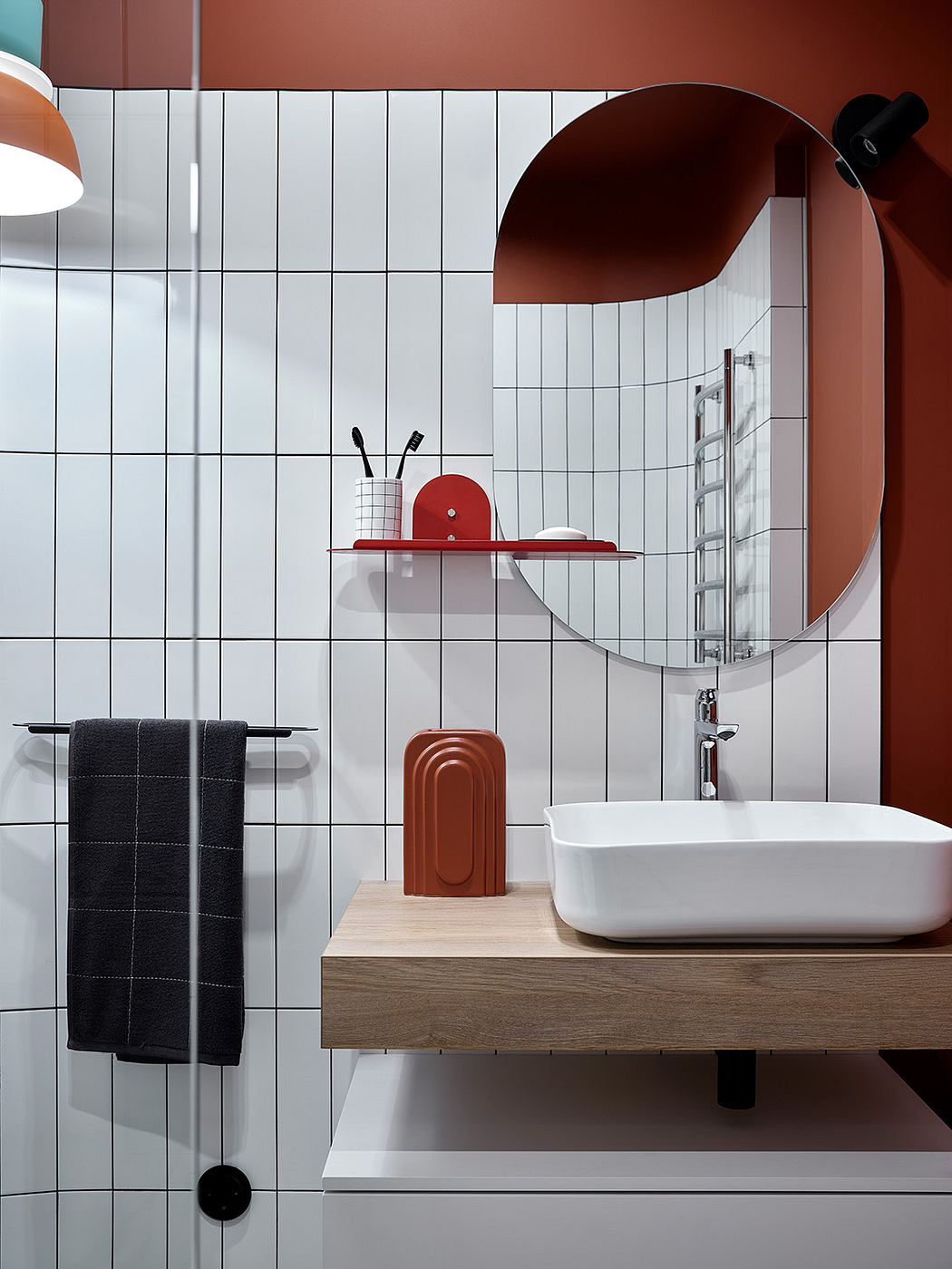 A modern bathroom with sleek red and white accents, a floating vanity, and an arched mirror.