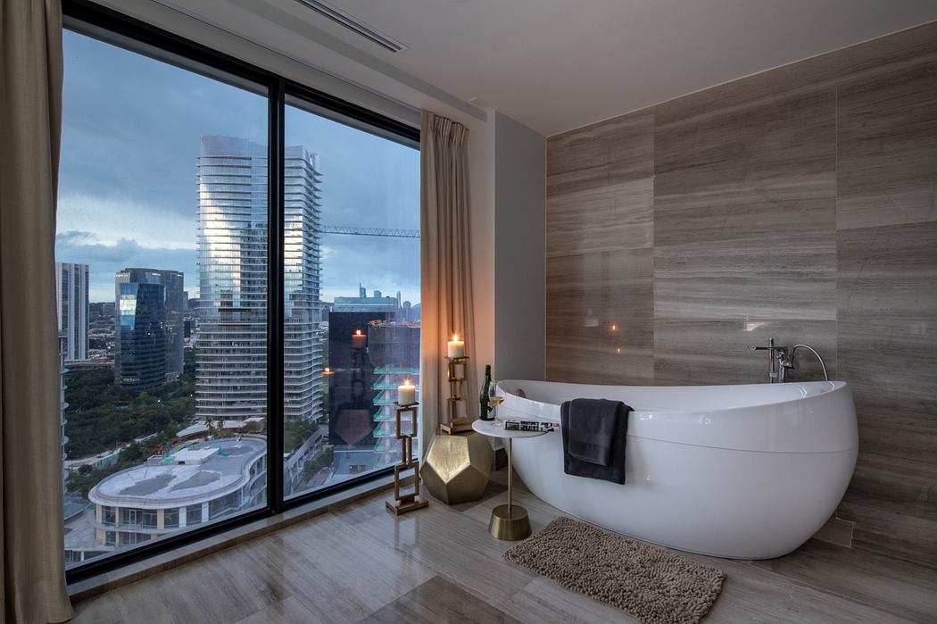 A modern bathroom with a freestanding bathtub, floor-to-ceiling windows, and city skyline view.