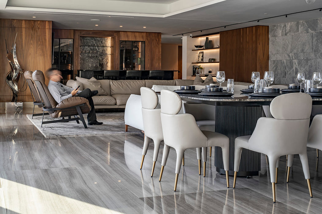 Sleek modern living space with elegant dining table, plush seating, and wood accents.