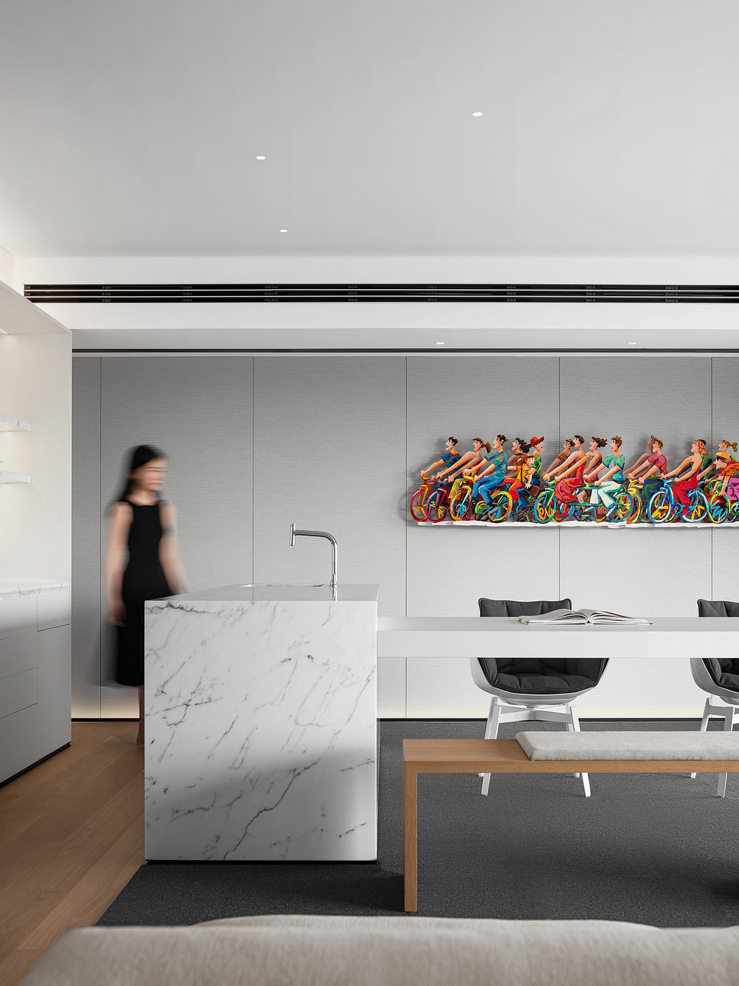 Clean, modern kitchen with marble island and colorful bicycle wall art.