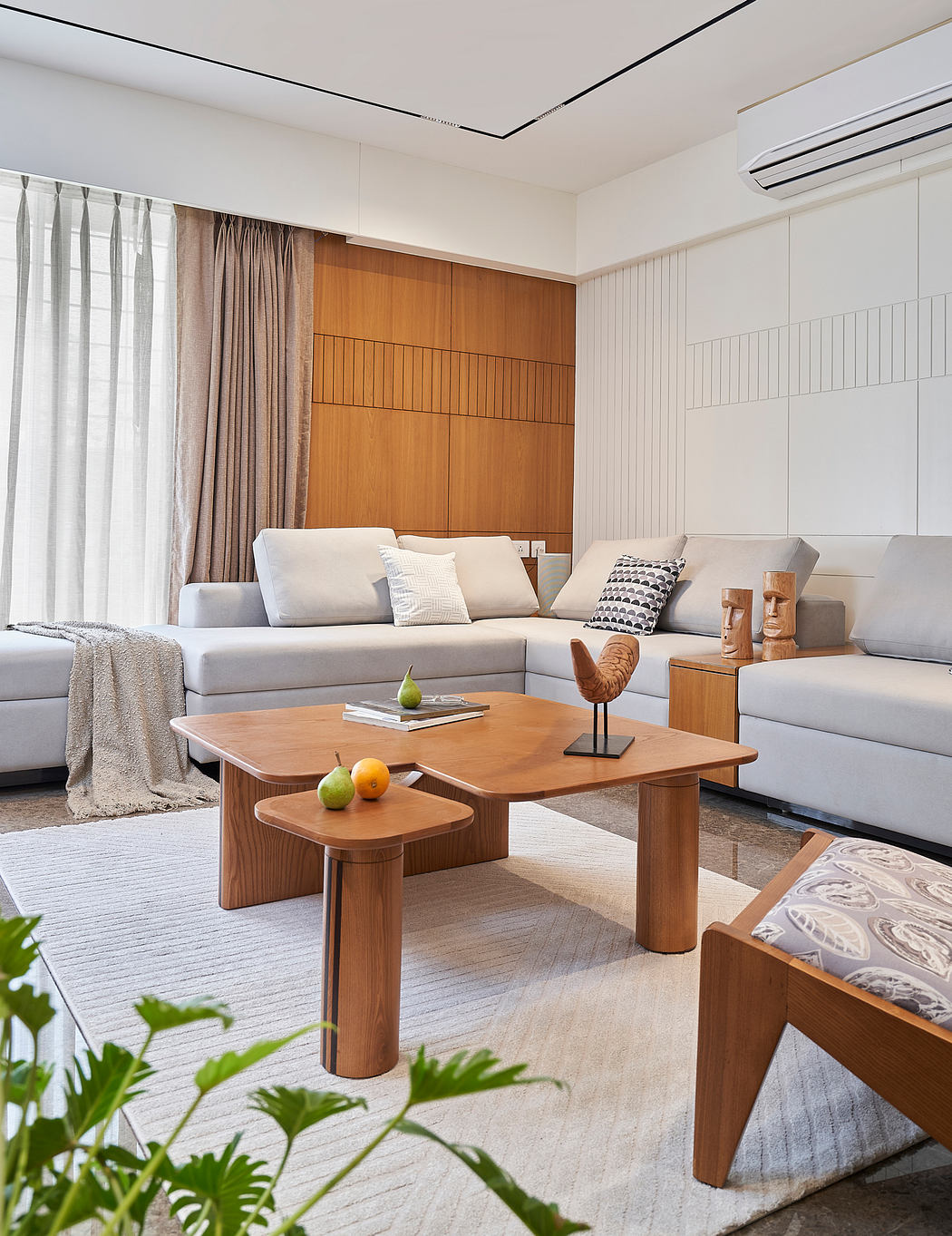 Spacious living room with wooden accent walls, modular couch, and custom coffee table.