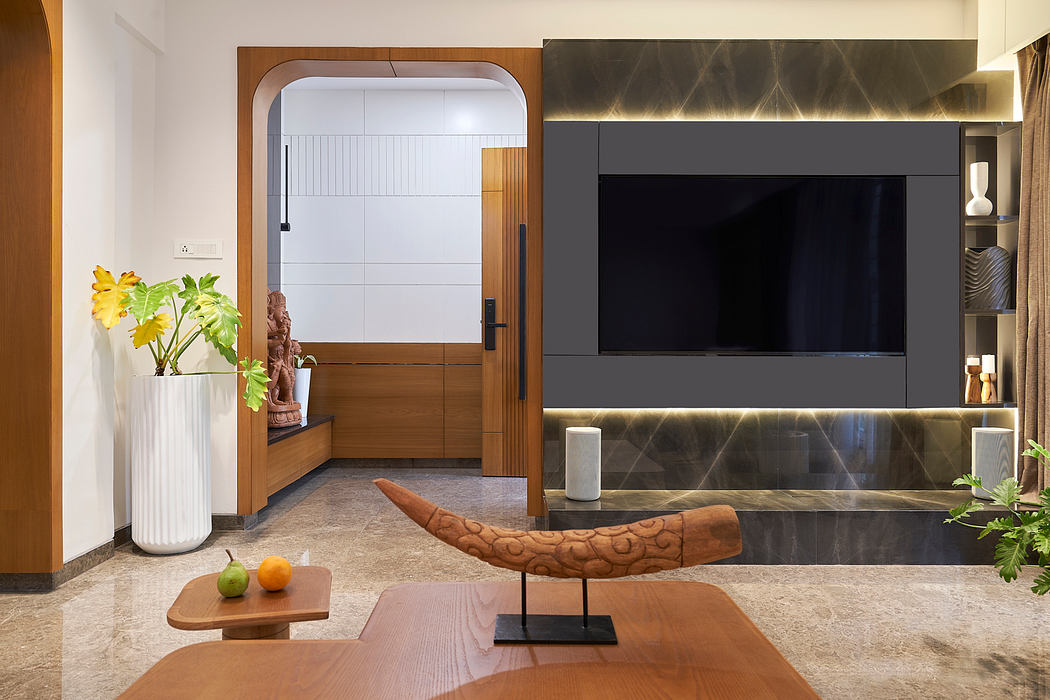 Modern living room with wooden accents, built-in TV display, and sculptural decorative elements.