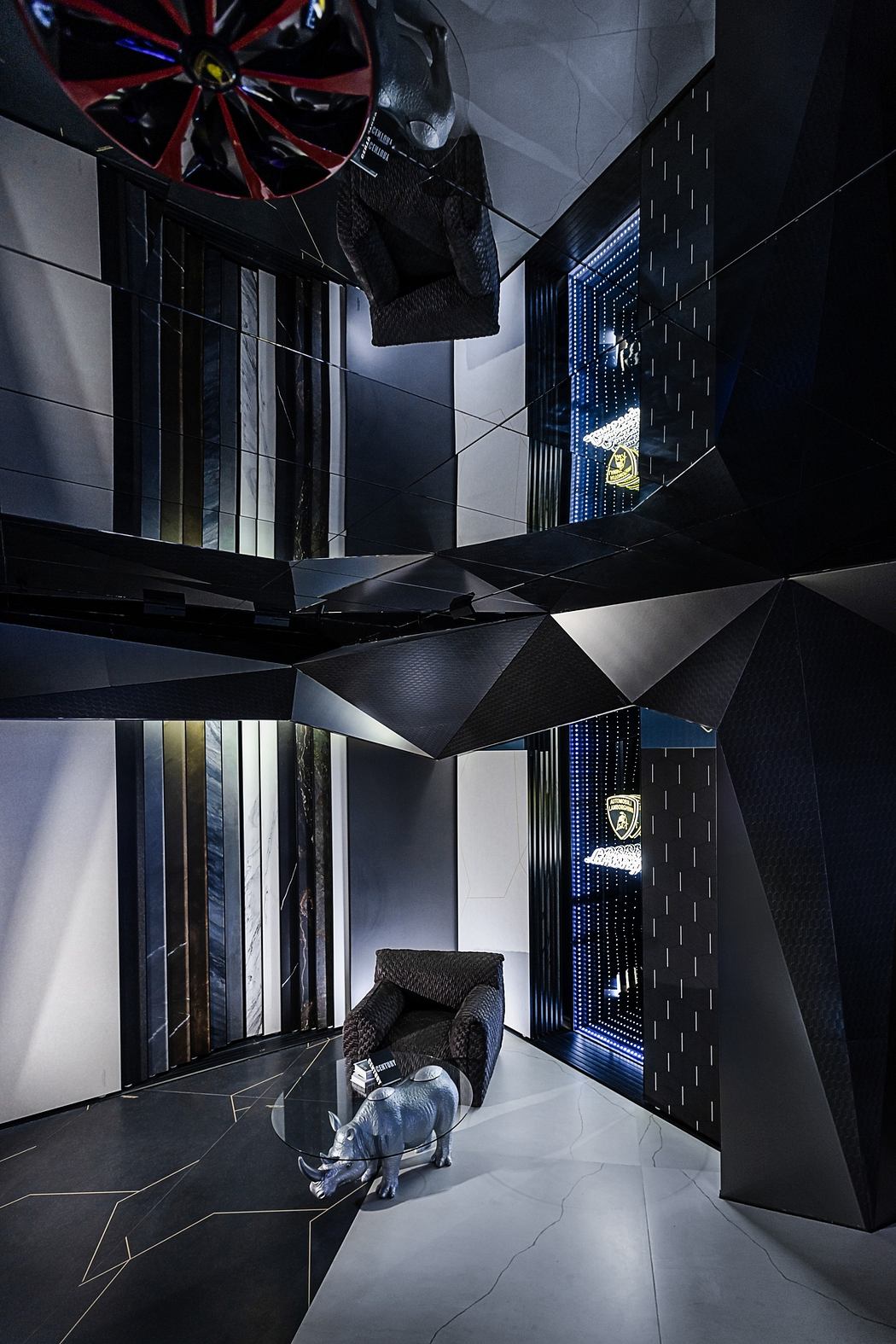 A futuristic interior with angular black and white design elements, including a glass sculpture of an animal.