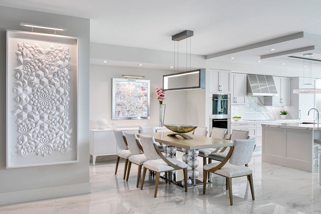 Elegant open-concept kitchen and dining room with modern geometric artwork.