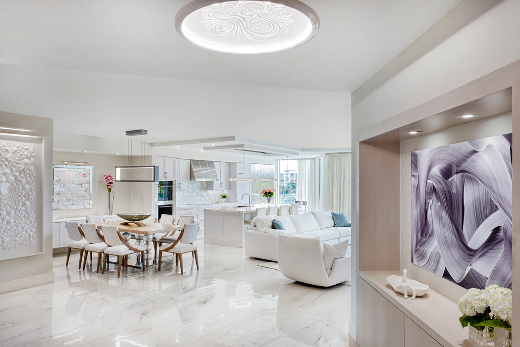 Luxurious open-concept living space with modern marble floors, sleek cabinetry, and stylish decor.