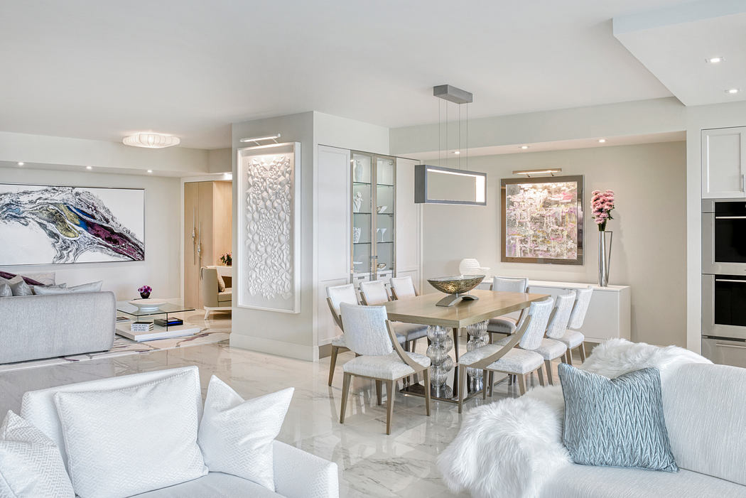 Stylish modern open-concept layout with sleek furniture, artwork, and lighting fixtures.