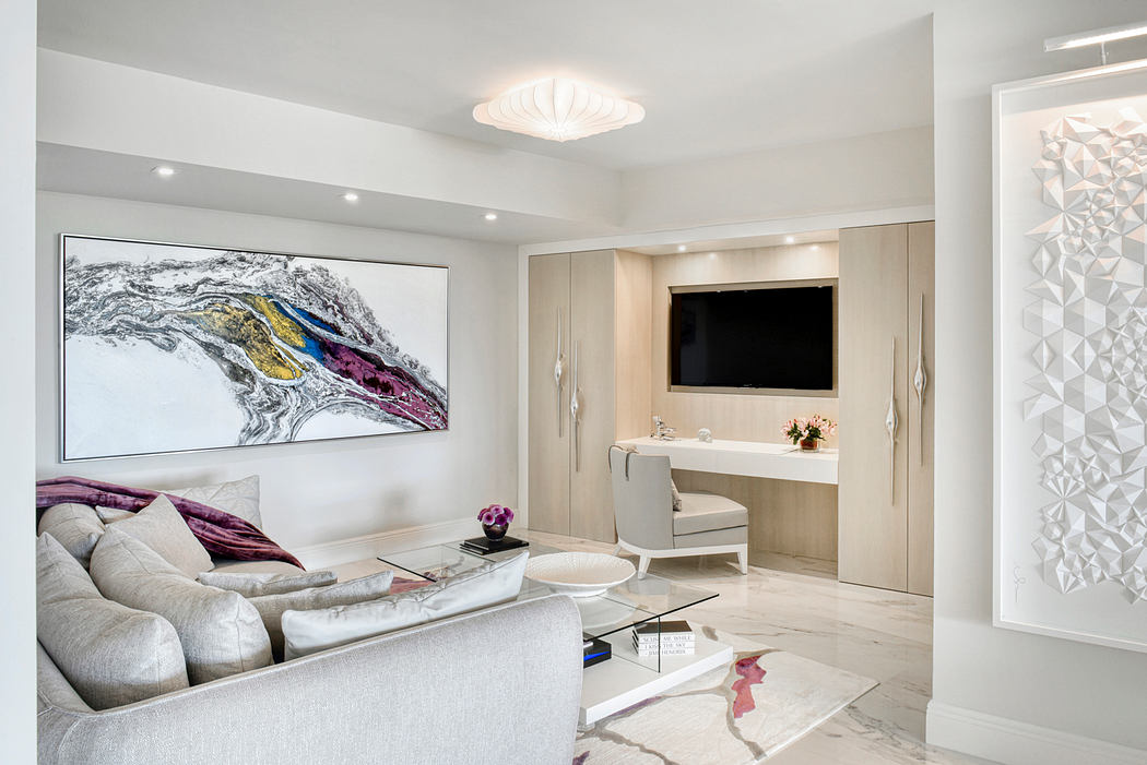 Sleek, modern living space with abstract artwork, built-in vanity, and geometric lighting.