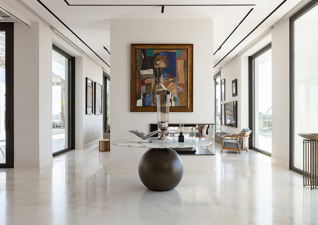 Elegant modern interior with minimalist decor, abstract artwork, and sleek marble flooring.
