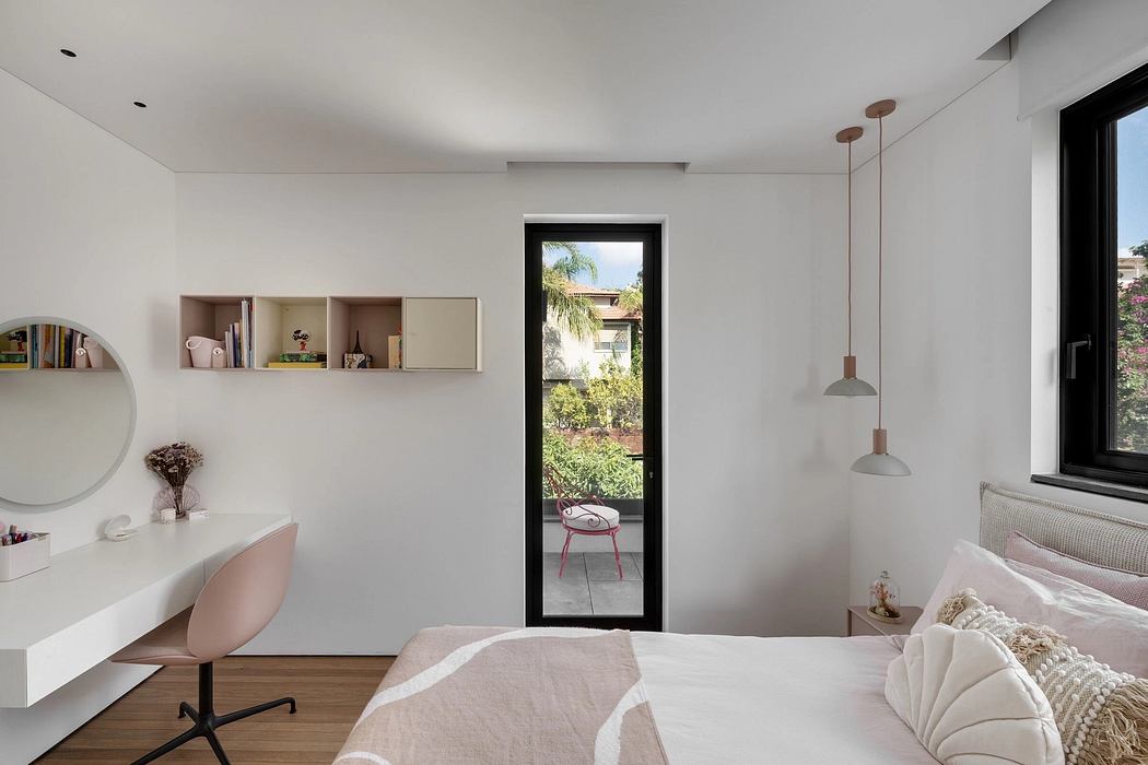 Bright and airy bedroom with minimalist shelves, vanity, and sliding glass door leading to lush greenery.