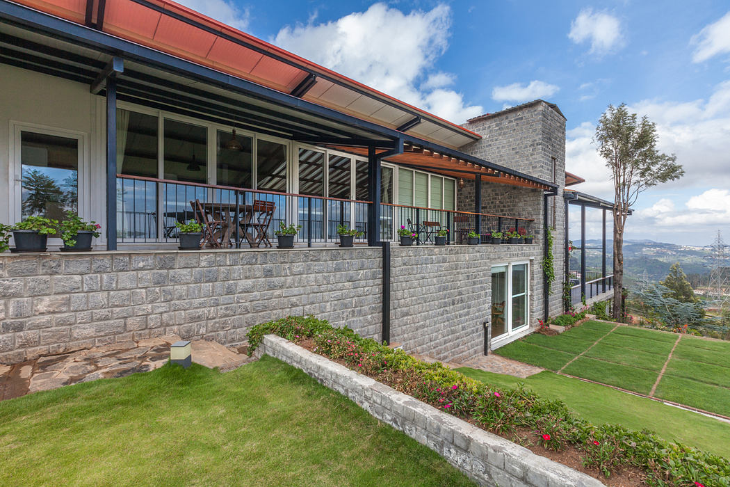 Expansive covered balcony overlooking lush landscaped grounds and scenic views.