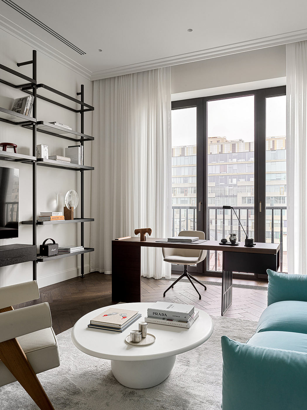 Minimalist home office with sleek shelving, large windows, and stylish furnishings.