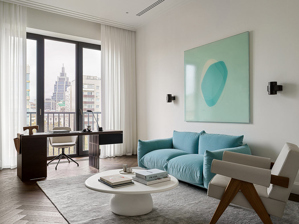 Sleek modern apartment with turquoise sofa, artwork, and impressive city view.